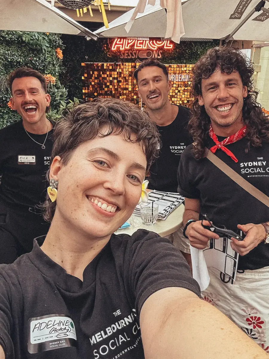 Club hosts smiling together at a social event