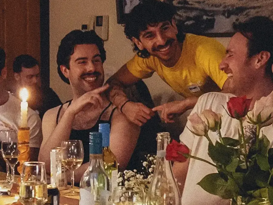 Members laughing over dinner at a club event
