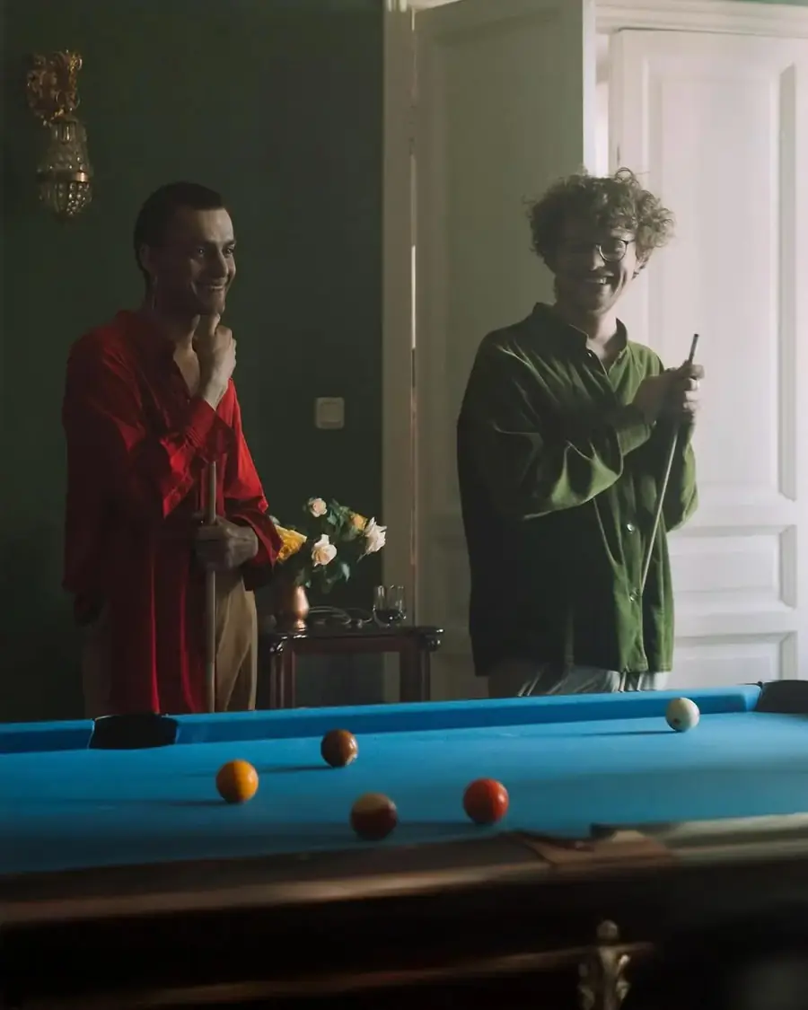 Two friends laughing over a game of pool