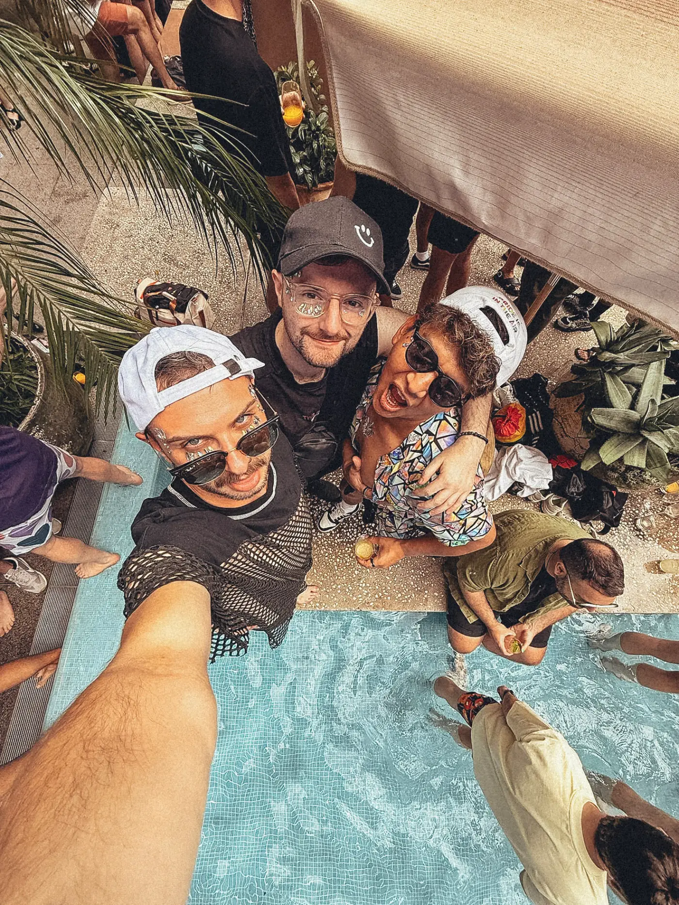 Three members laughing together at a pool party